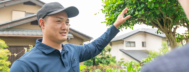 男性スタッフがお客様と草刈りについて丁寧にお話ししている